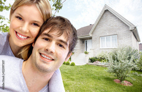 Happy couple near new house. © grinny