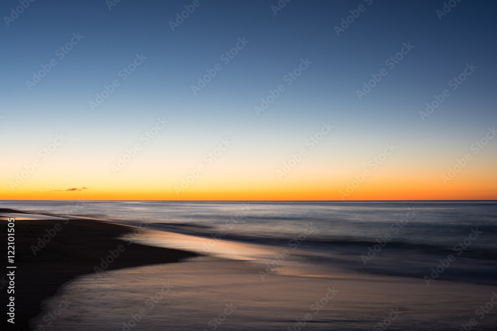 The sun rises across the Atlantic Ocean from east Long Island, New York