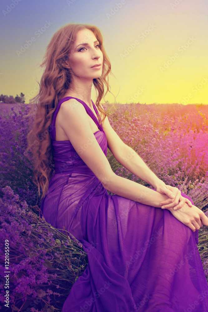 Young woman with long blonde hair in a purple dress looking at t Stock  Photo | Adobe Stock