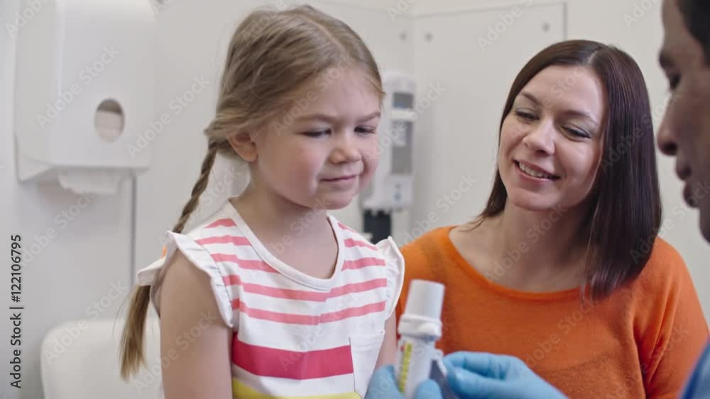 Shy little girl blowing into breathalyzer during hydrogen breath test