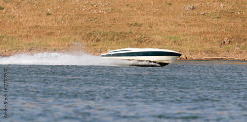 Boat floats on the lake speed photo