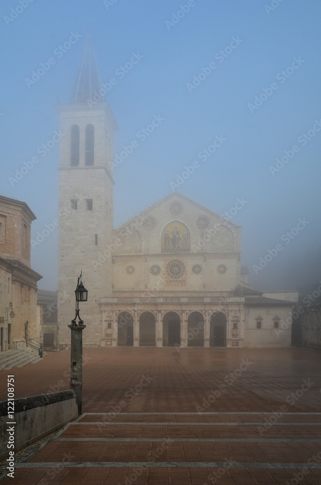 Spoleto (Italy) - A misty fall day in the charming medieval village in Umbria region. The soft focus depends on dense fog, which, however, creates an evocative atmosphere with Sun rays 