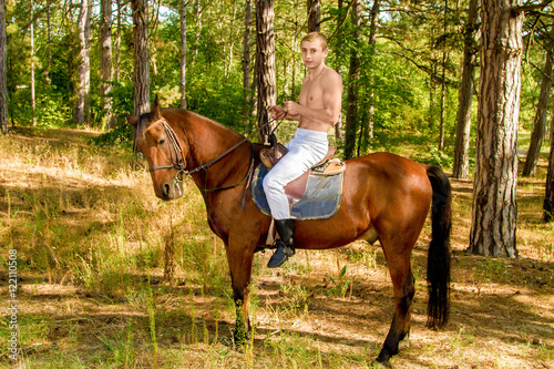 young man in the forest on horseback © Vadim Hnidash