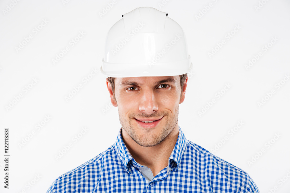 Closeup of smiling young man builder in hard hat Closeup of smiling young man builder in hard hat