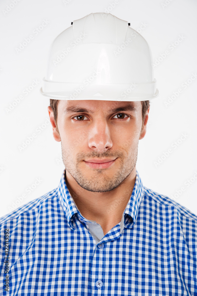 Closeup of serious young man building engineer in helmet Closeup of serious young man building engineer in helmet