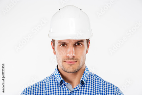 Portrait of serious young man architect in building helmet © Drobot Dean