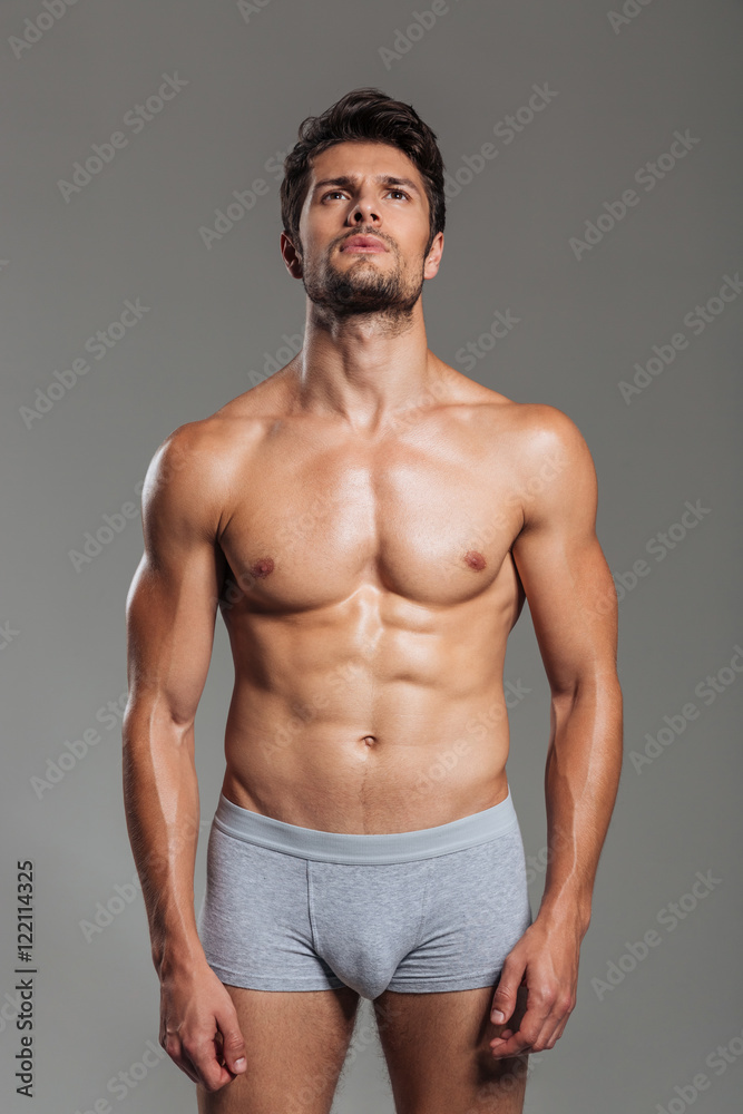 Portrait of handsome sexy athletic man in underwear posing Photos | Adobe  Stock