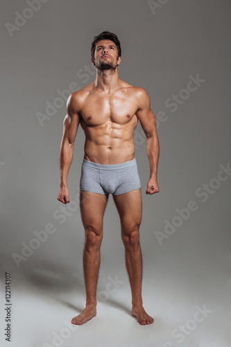 Handsome sexy athletic man in underwear posing and looking up