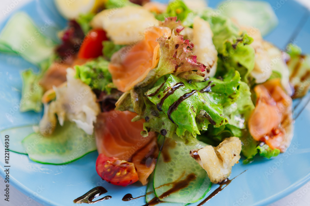 Healthy restaurant food, salmon and cod fish salad closeup Healthy restaurant food, salmon and cod fish salad closeup