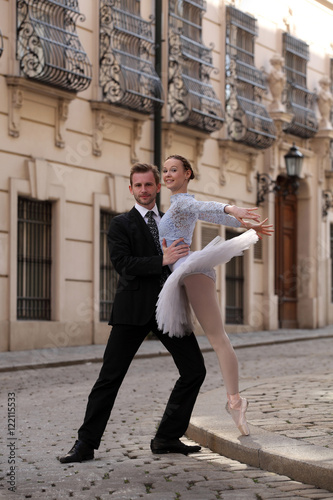 Handsome young man with a ballerina on the street