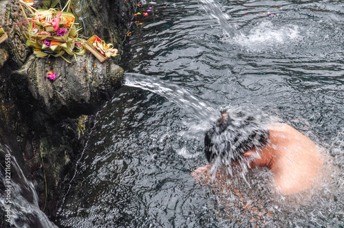 A man cleansing in the Holy Spring at Tirtha Empul Temple Bali,Indonesia