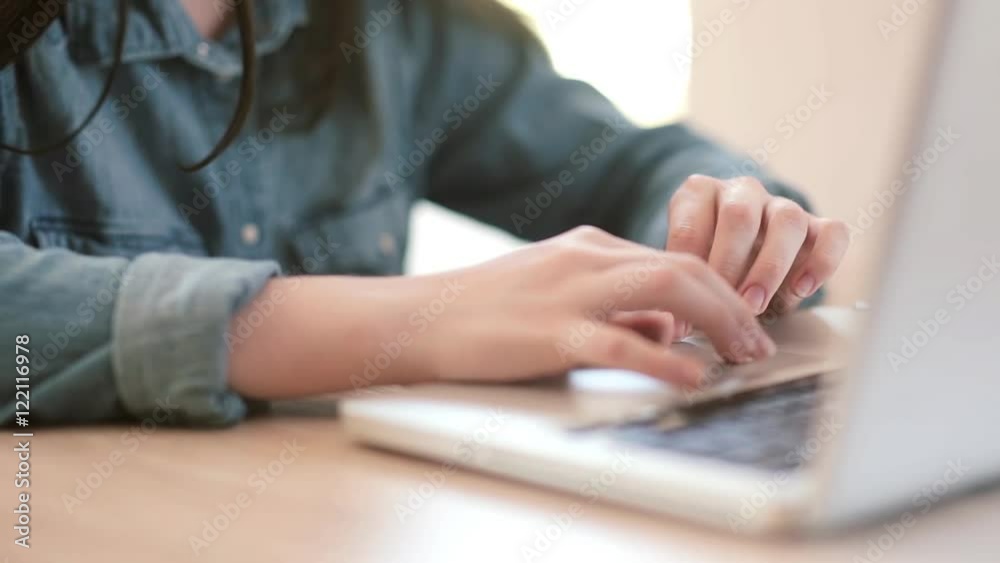 Hands teenage girl working on laptop in the room Hands teenage girl working on laptop in the room
