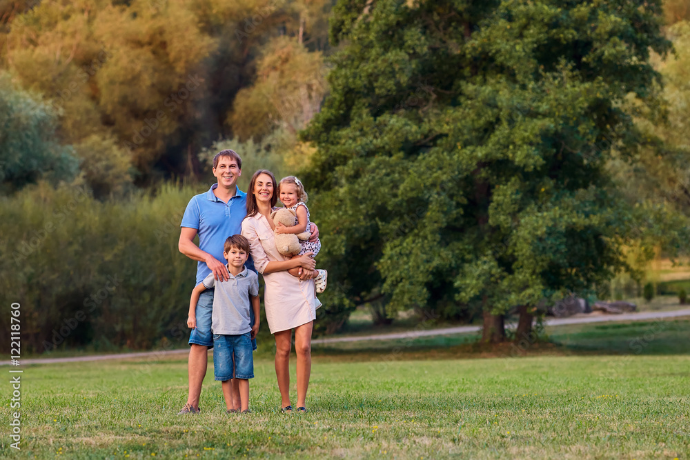 Fototapeta premium Happy family in the park summer, autumn. Portrait of a father, m