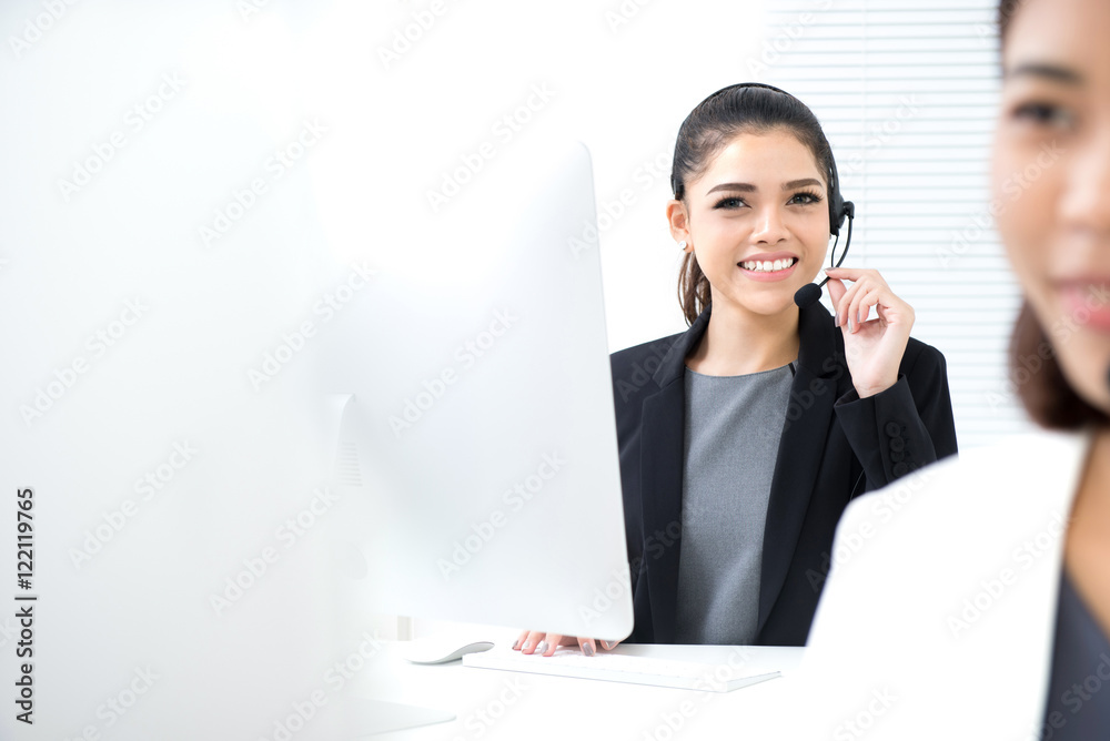Young Asian businesswoman working as an operator in call center Young Asian businesswoman working as an operator in call center