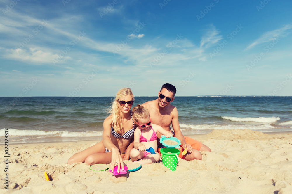 happy family playing with sand toys on beach happy family playing with sand toys on beach