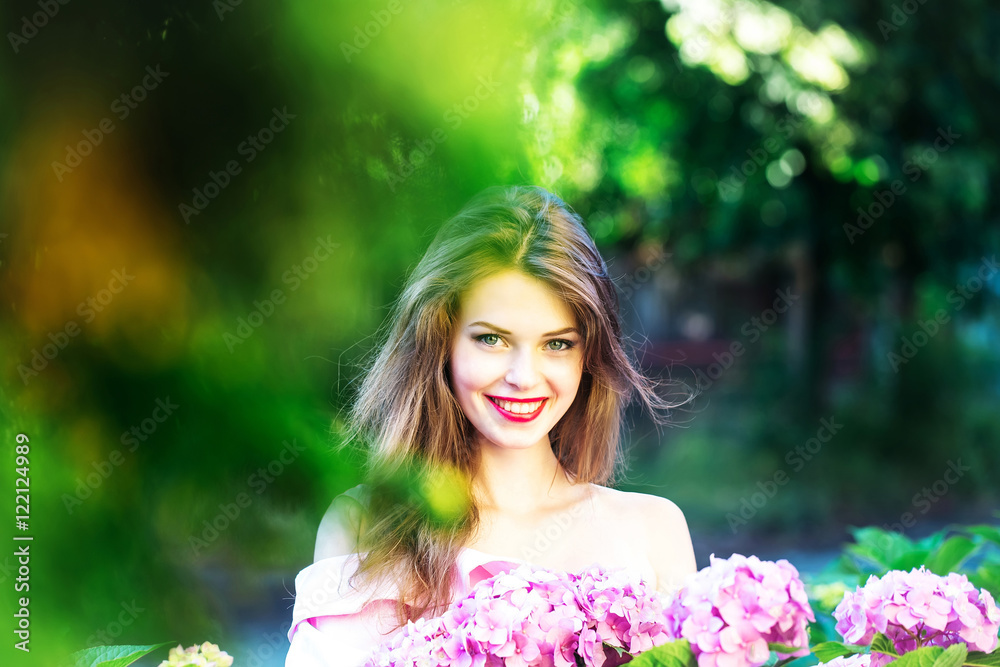 pretty smiling girl in hydrangea flowers pretty smiling girl in hydrangea flowers