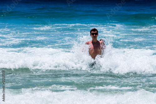 girl bathes in the ocean waves