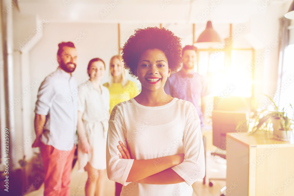 happy young woman over creative team in office happy young woman over creative team in office