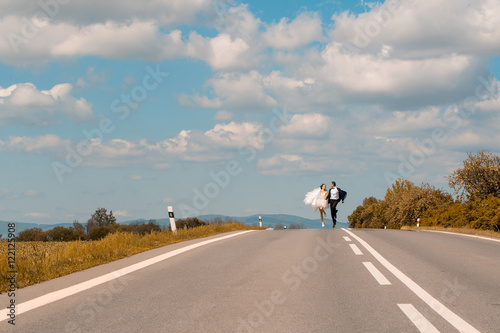 Married couple run along road