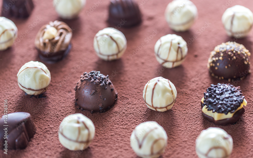 Chocolate candies on cocoa background Chocolate candies on cocoa background