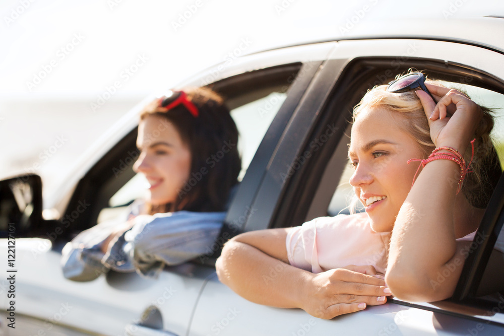 happy teenage girls or women in car at seaside happy teenage girls or women in car at seaside