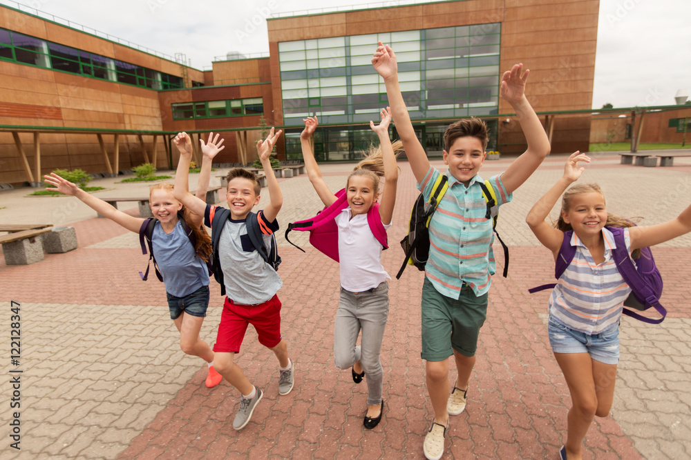Fototapeta premium group of happy elementary school students running
