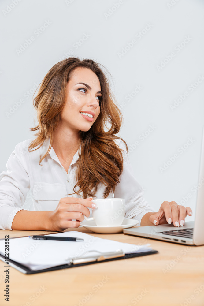 Happy beauitful young businesswoman sitting and working with laptop Happy beauitful young businesswoman sitting and working with laptop
