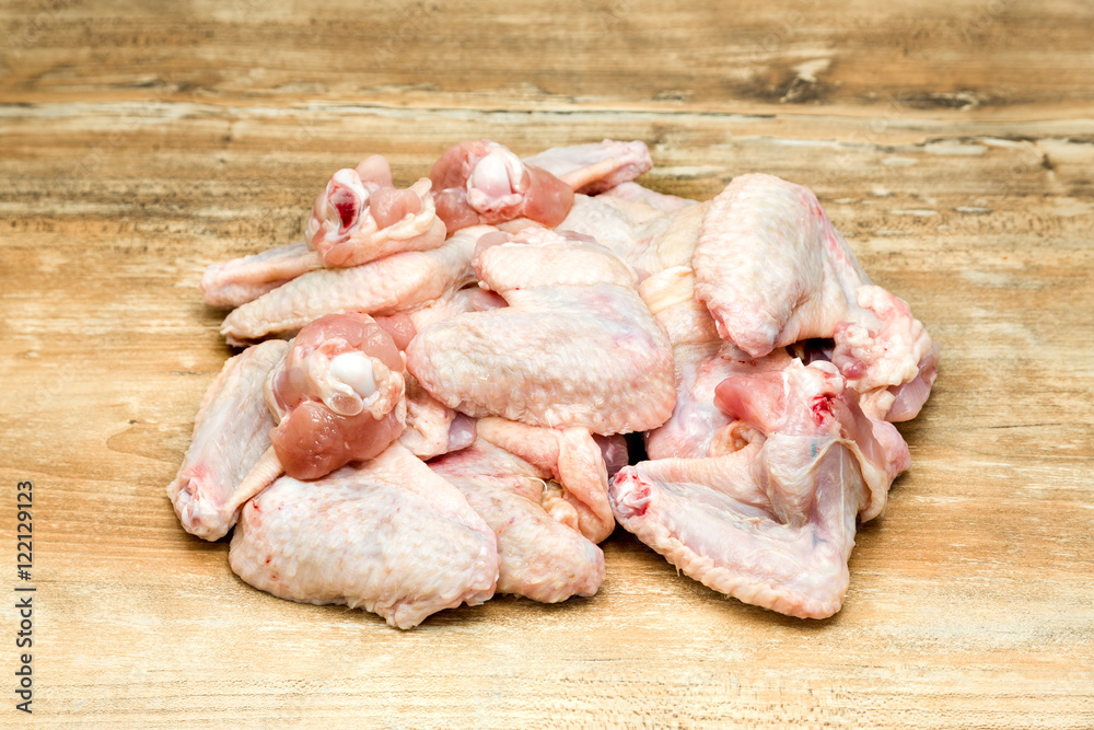 raw chicken wings on wooden table raw chicken wings on wooden table