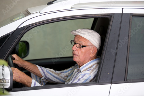 Senior man driving car © Budimir Jevtic