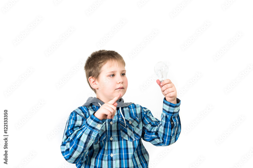 Smiling child holding tablet PC in hands. Idea concept. Photo shoot in the studio boy with tablet and a bulb-to-day knowledge Smiling child holding tablet PC in hands. Idea concept. Photo shoot in the studio boy with tablet and a bulb-to-day knowledge