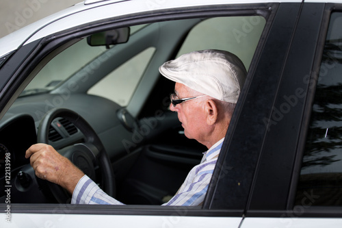 Senior man driving car © Budimir Jevtic