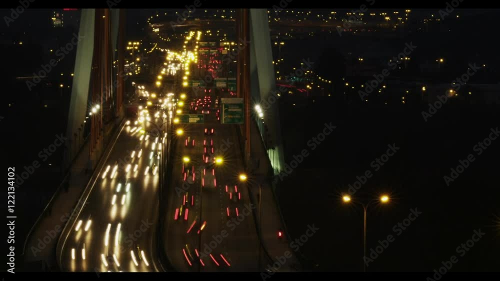 Time laps of cars on bridge in night shot. Busy big city life in Warsaw.