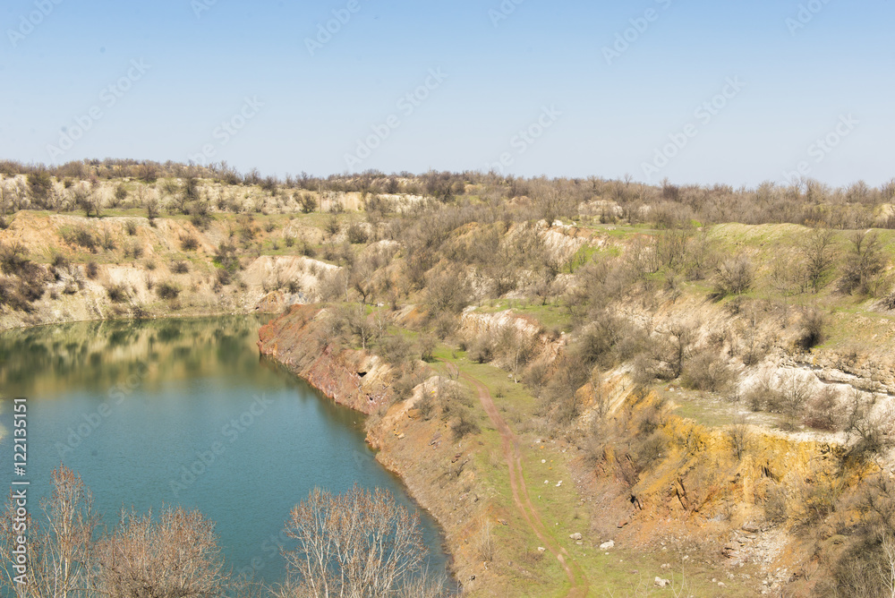 Aerial view of open pit mining of iron ore. Lake in an abandoned mine. Aerial view of open pit mining of iron ore. Lake in an abandoned mine.