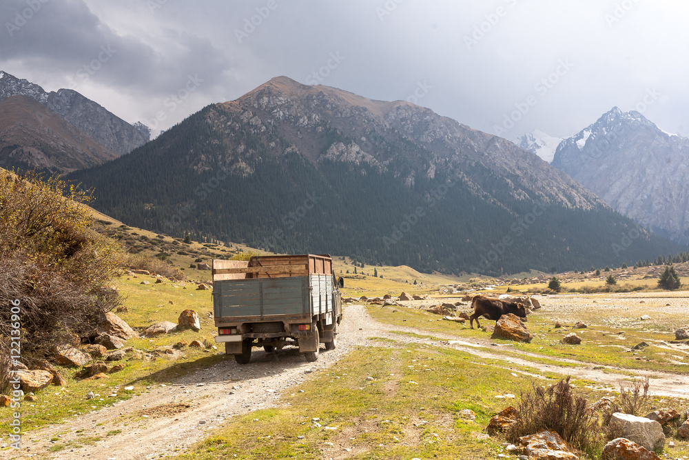 Naklejka premium Mountain landscape with old car of Tien Shan.