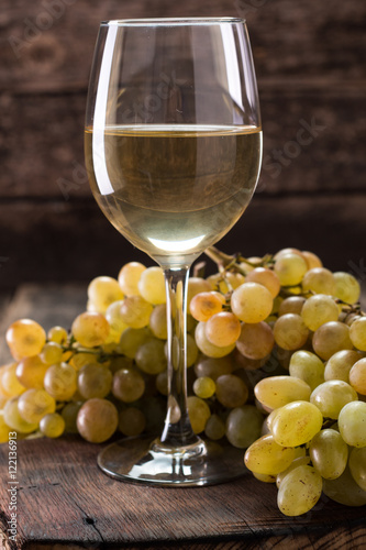 White wine and grapes.Wine and grapes on vintage wooden table