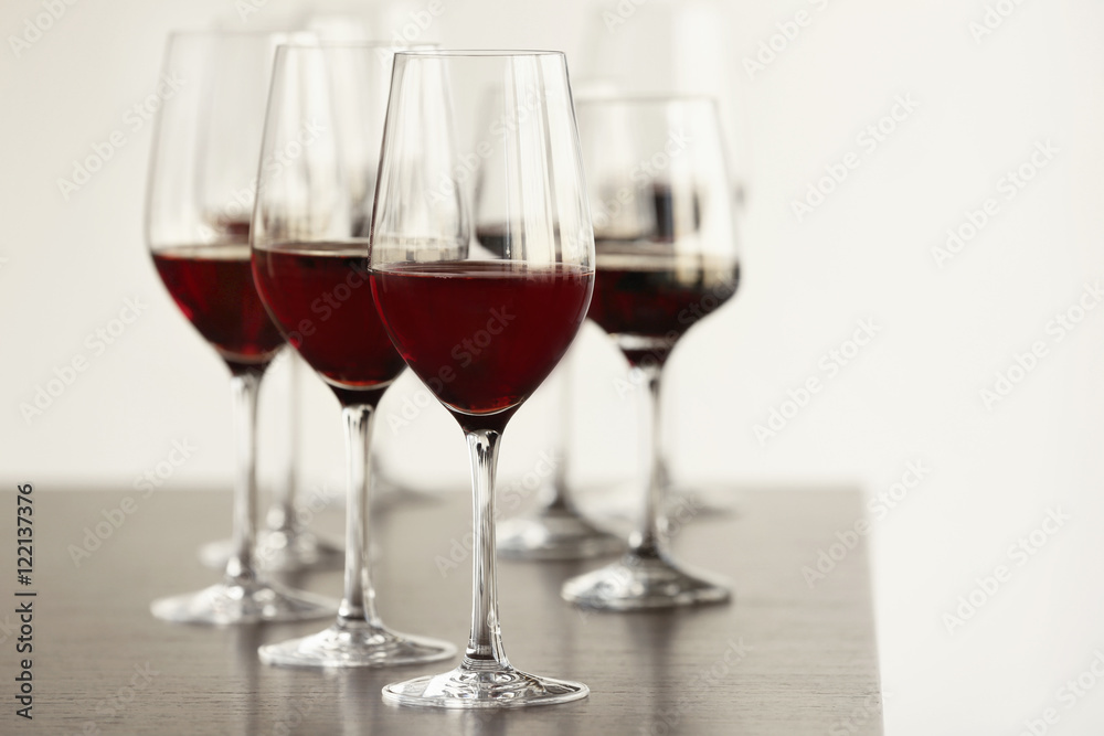 Glasses with red wine in a row on a table Glasses with red wine in a row on a table