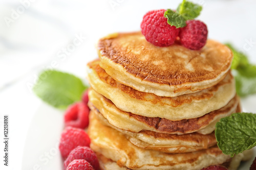 Tasty pancakes with berries and mint, closeup
