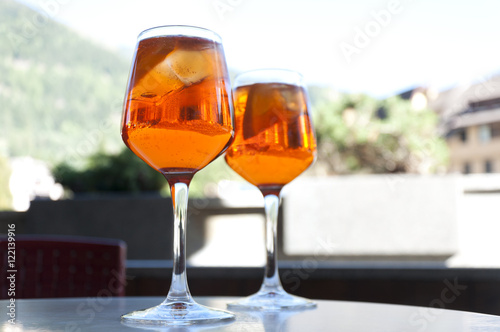 two glasses with a cocktail Aperol in a street cafe in Italy