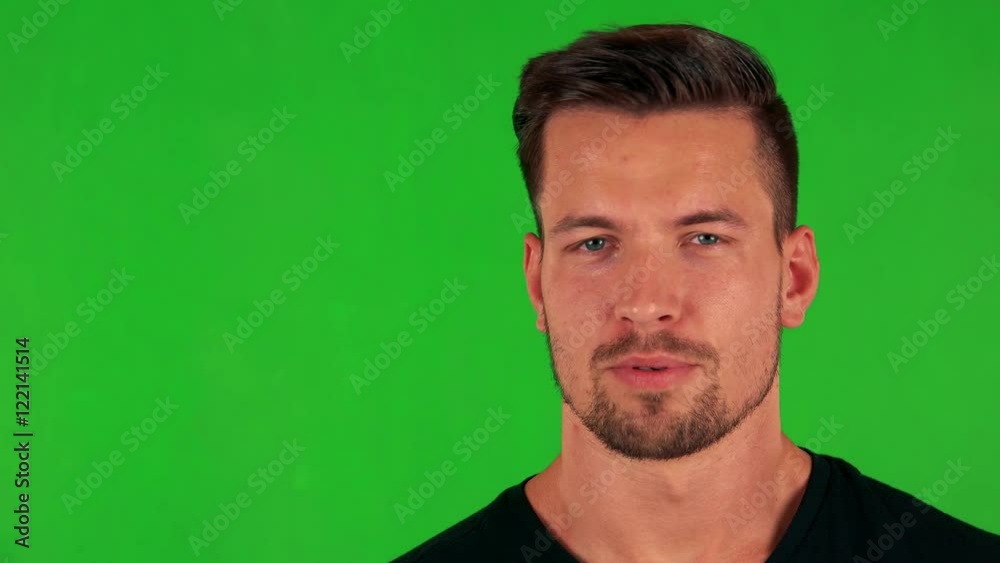 young handsome caucasian man talks to camera - green screen - studio - closeup young handsome caucasian man talks to camera - green screen - studio - closeup