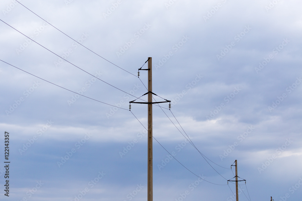 electric poles against the sky with clouds electric poles against the sky with clouds