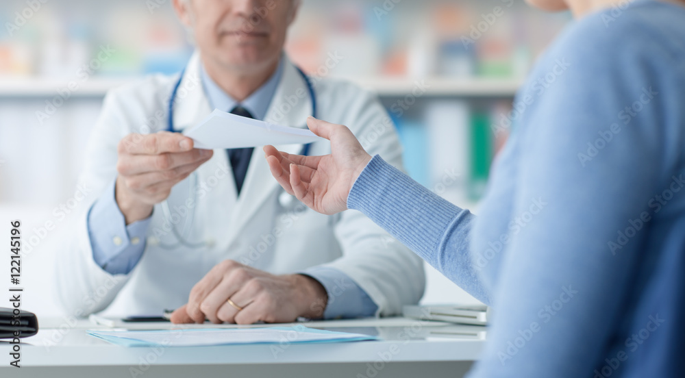 Doctor giving a medical prescription to the patient Doctor giving a medical prescription to the patient