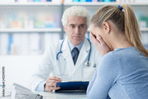 Woman receiving bad news from her doctor
