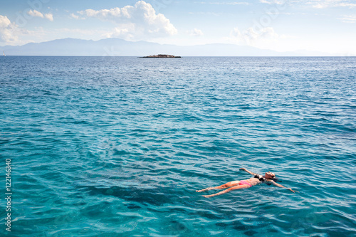 Swimming blue lagoon. Woman and ocean.