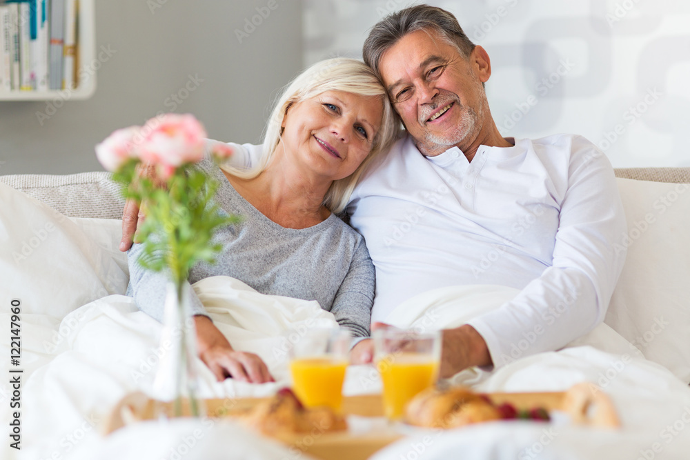 Senior couple enjoying breakfast in bed
