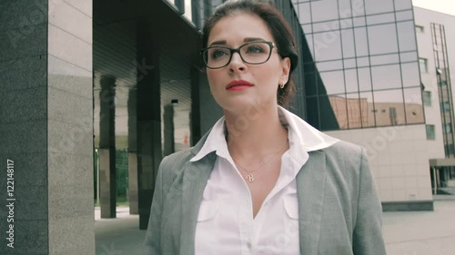 Stylish business woman walking along business centre