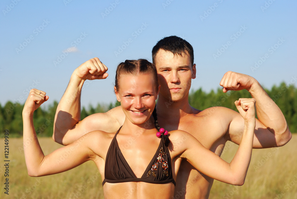 Happy young couple doing morning sports exercises Happy young couple doing morning sports exercises