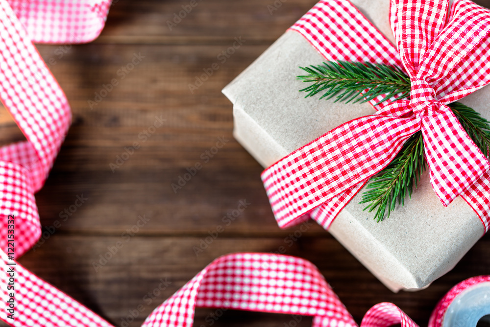 Christmas gift box in rustic package, present wrapped in paper and ribbon