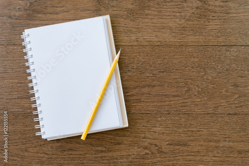 blank white notebook on wooden texture background