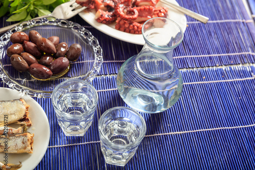 Two glasses of ouzo and appetizers photo