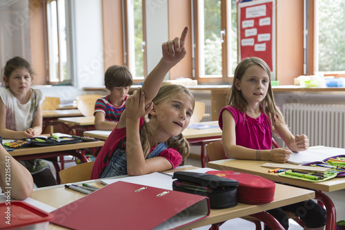 Schoolgirl raising her hand photo